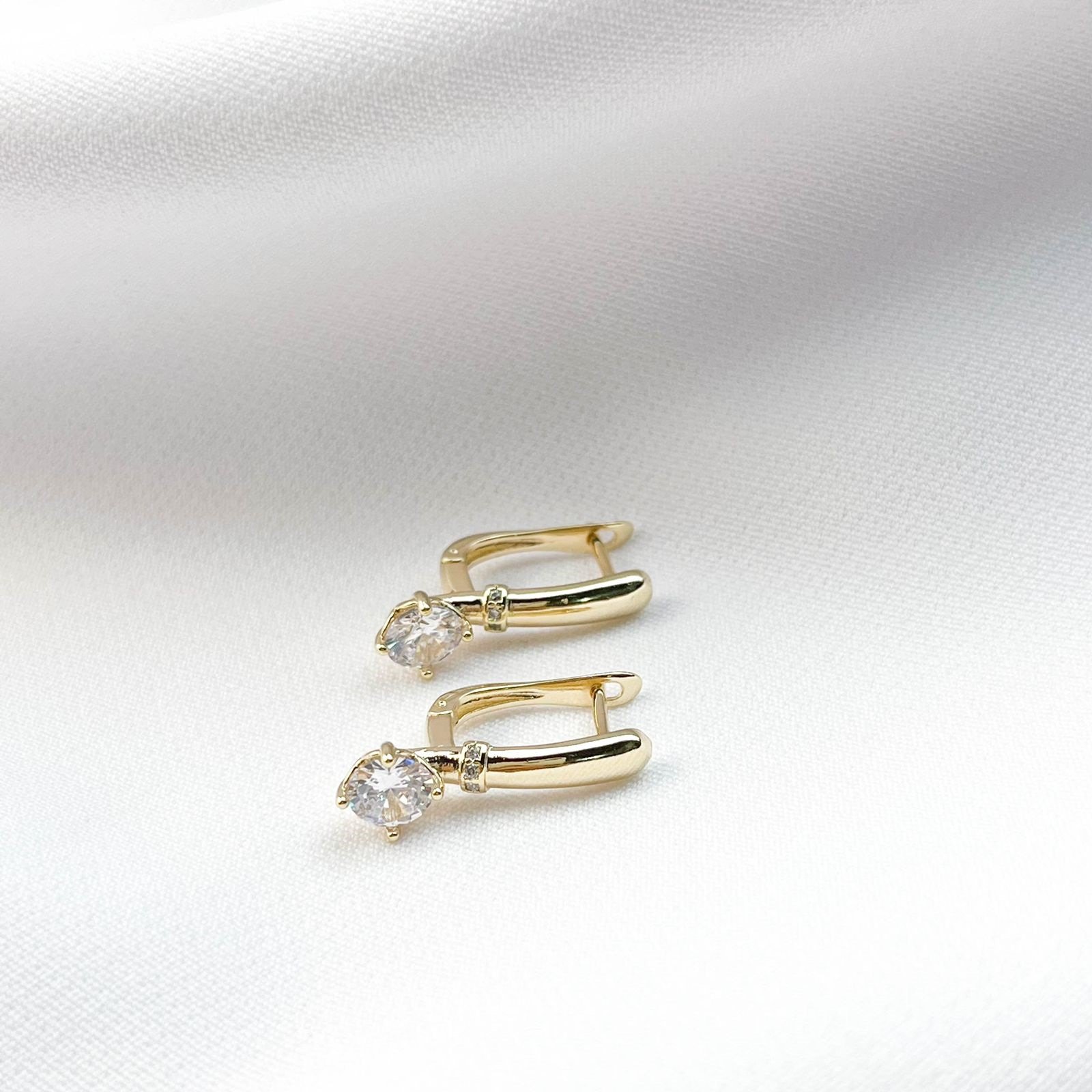 BRINCO ARTICULADO COM DETALHE EM ZIRCONIA E PONTO DE LUZ EM OURO 18K