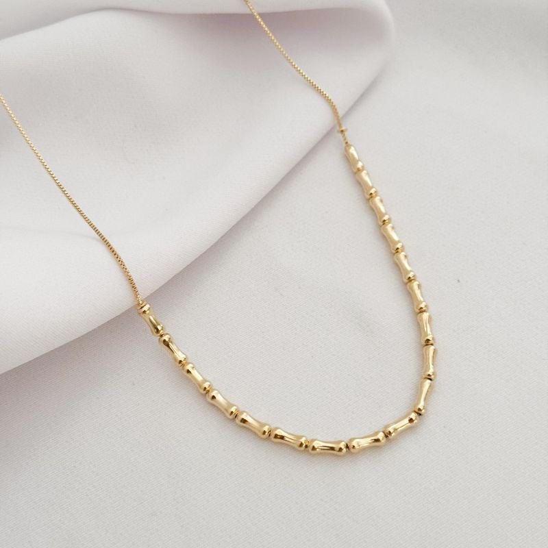 COLAR OSSINHO DE METAL EM OURO 18K