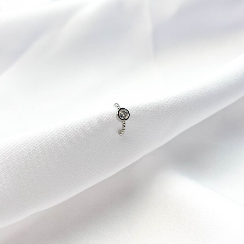 PIERCING COM PONTO DE LUZ EM RÓDIO BRANCO
