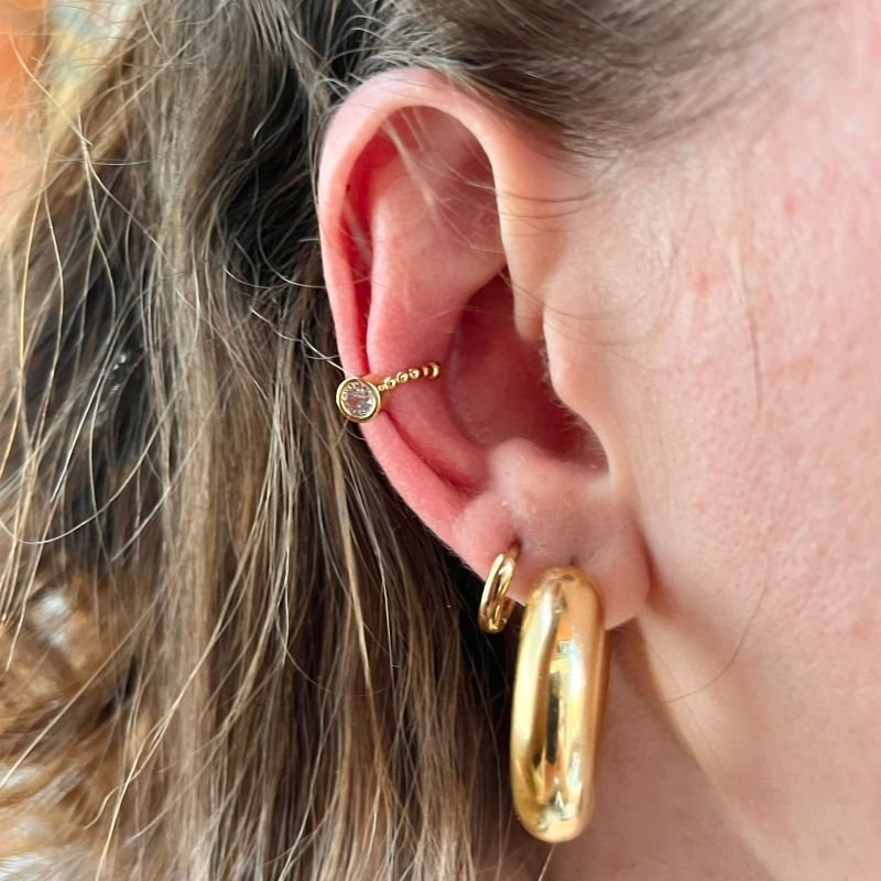 PIERCING COM PONTO DE LUZ EM RÓDIO BRANCO