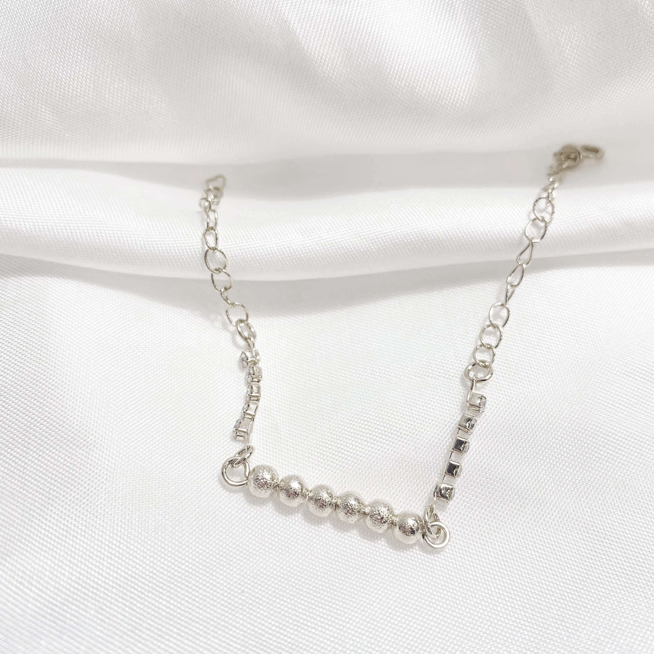PULSEIRA BOLINHAS E ZIRCONIAS 18CM + EXTENSOR EM RÓDIO BRANCO