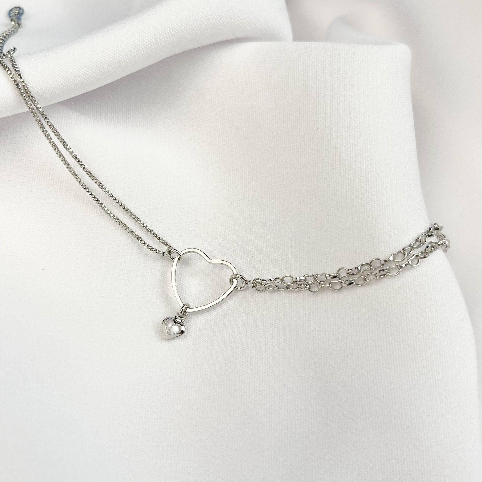 PULSEIRA CORRENTE DUPLA E CORAÇÃO VAZADO COM PONTO DE LUZ EM RÓDIO BRANCO