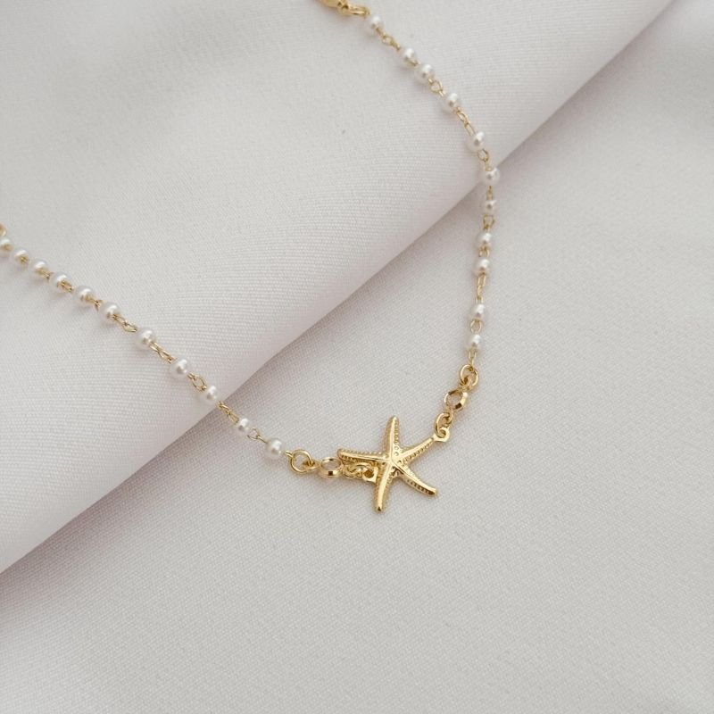 PULSEIRA DE PEROLA COM ESTRELA DO MAR E ZIRCONIA EM OURO 18K