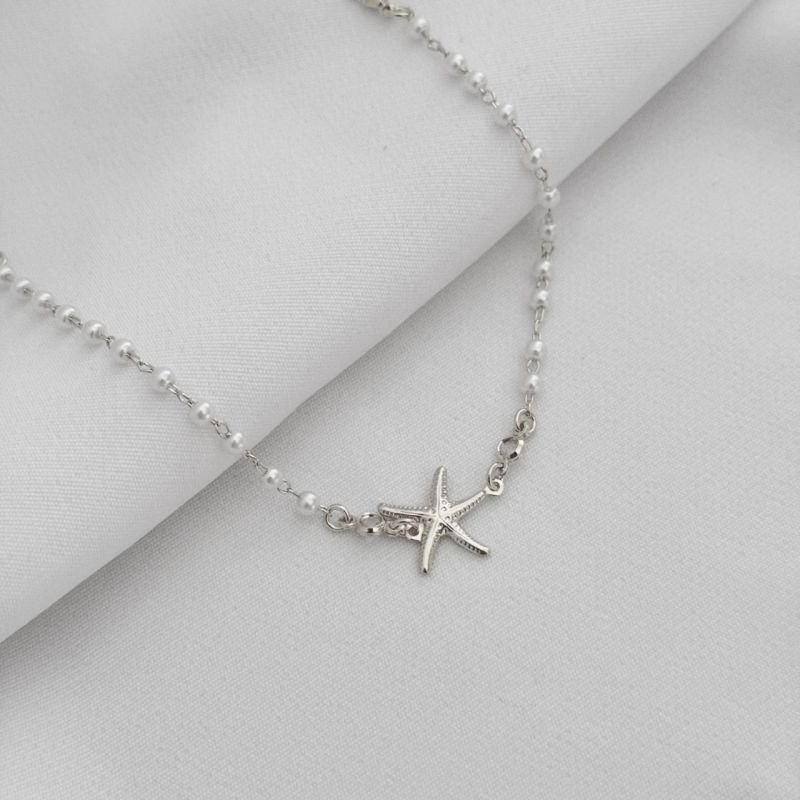 PULSEIRA DE PEROLA COM ESTRELA DO MAR E ZIRCONIA EM RÓDIO BRANCO